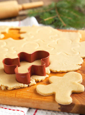 Cutting gingerbread cookies dough homemade for Christmasの写真素材