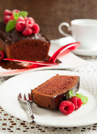 Chocolate loaf cake with chocolate frosting and raspberryの写真素材