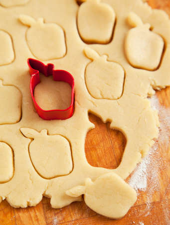 Apple shaped cookie cutter on raw cookie dough  Selective focusの写真素材