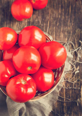 Fresh tomatoes in basket  Selective focusの写真素材