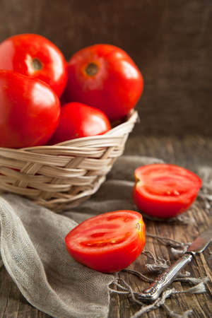 Fresh tomatoes in basket  Selective focusの写真素材
