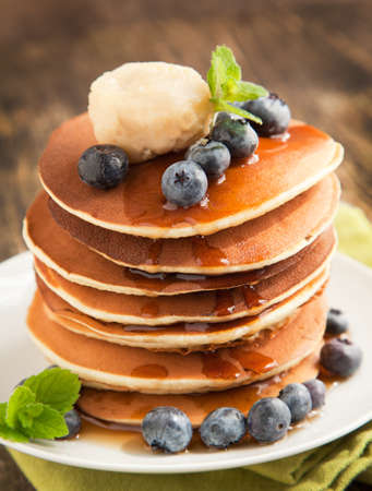Stack of pancakes with fresh blueberry,maple butter and syrupの写真素材
