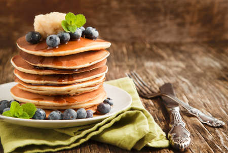 Stack of pancakes with fresh blueberry,maple butter and syrupの写真素材