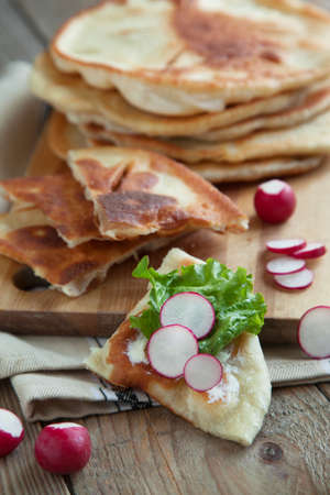 Homemade milk flatbread with cream cheese, lettuce and radishの写真素材