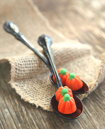 Pumpkin candy in black spoonの写真素材