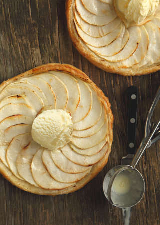 Apple tart with vanilla ice cream on wooden backgroundの写真素材
