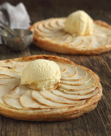 Apple tart with vanilla ice cream on wooden backgroundの写真素材