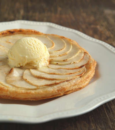 Apple tart with vanilla ice cream on wooden backgroundの写真素材