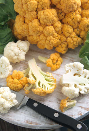 Orange and White Cauliflower on chopping boardの写真素材