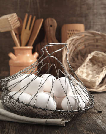 Eggs in the Basket and kitchen cooking utensils, tonedの写真素材