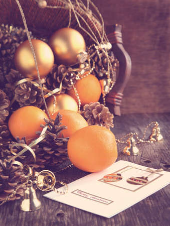 Christmas Card with Christmas decoration, oranges and pine conesの写真素材
