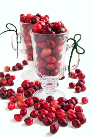 Ripe cranberries in glass cups on white backgroundの写真素材