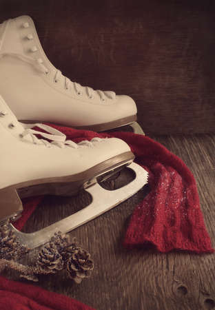 Skates for figure skating on a wooden background, tonedの写真素材
