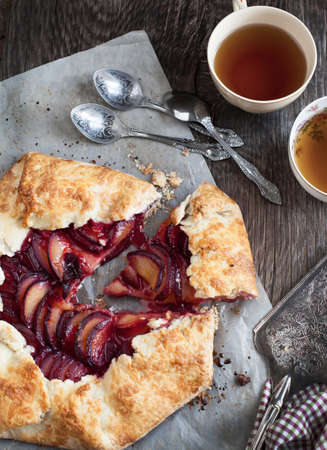 Fresh homemade plum galette on wooden tableの写真素材