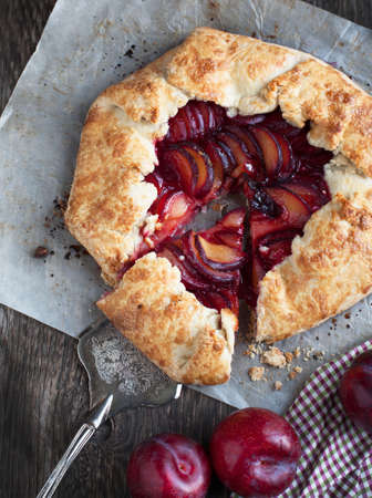 Fresh homemade plum galette on wooden tableの写真素材