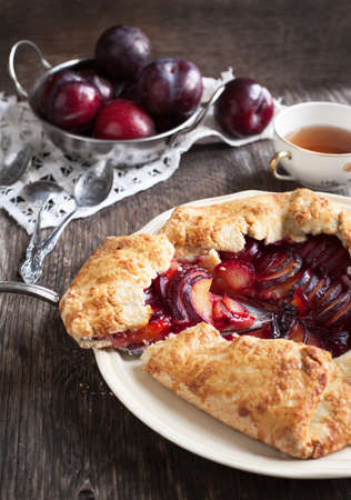 Fresh homemade plum galette on wooden tableの写真素材