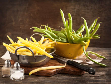 Fresh Green and Yellow Beans on wooden tableの写真素材