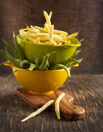 Fresh Green and Yellow Beans on wooden tableの写真素材