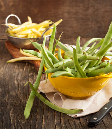 Fresh Green and Yellow Beans on wooden tableの写真素材
