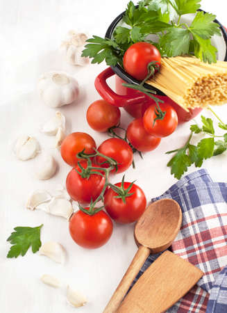 Italian Pasta with tomatoes, garlic, olive oil and italian parsley on wooden background の写真素材
