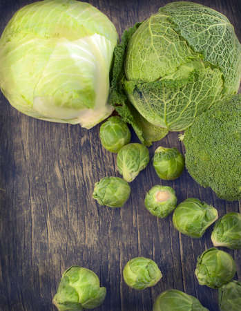 Assortment cabbages on wooden backgroundの写真素材