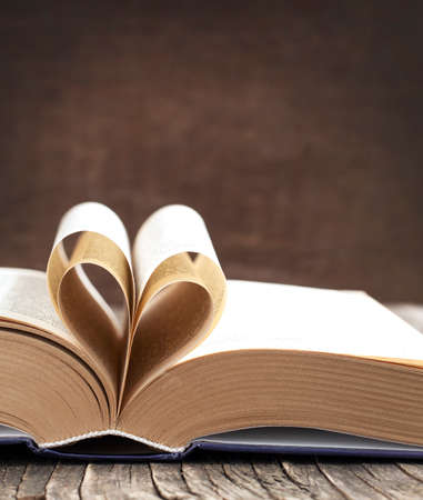 Pages of a book curved into a heart shapeの写真素材