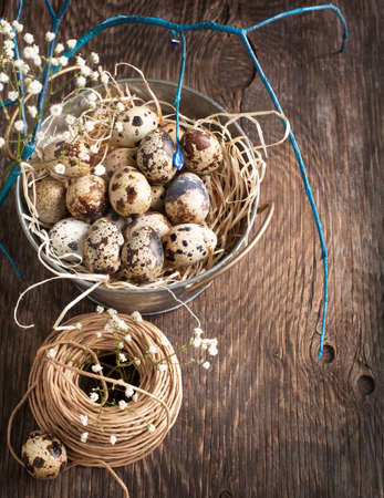 Easter decoration with quail eggs on wooden boardの写真素材