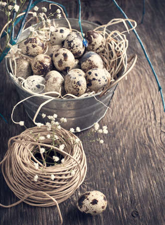 Easter decoration with quail eggs on wooden boardの写真素材