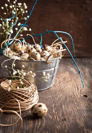 Easter decoration with quail eggs on wooden boardの写真素材