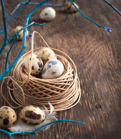 Easter decoration with quail eggs on wooden boardの写真素材