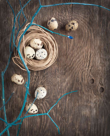 Easter decoration with quail eggs on wooden boardの写真素材