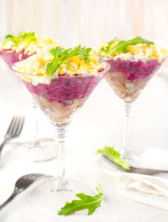 Beetroot salad with herring in a glassの写真素材