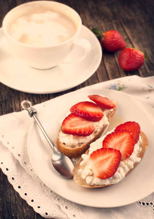 Fresh bread with Cottage cheese, strawberry and honey  Toned imageの写真素材