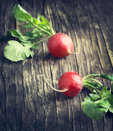Two fresh radish on wooden table の写真素材