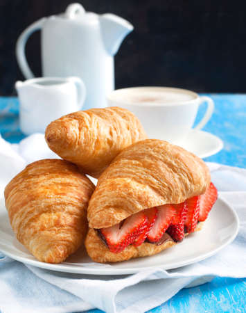 Fresh croissants with strawberry and chocolate nuts creamの写真素材