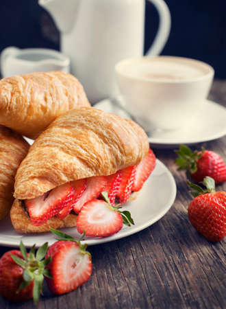 Fresh croissants with strawberry and chocolate nuts creamの写真素材