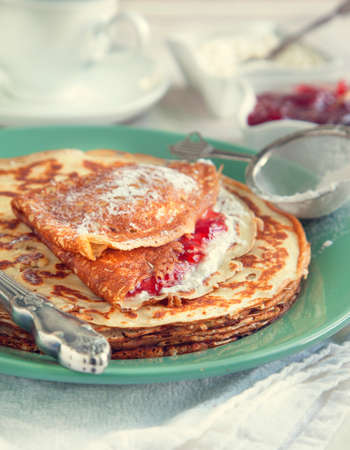 Crepes with cream cheese and strawberry jam  Toned imageの写真素材