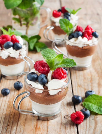 White chocolate and milk chocolate mousse with berries and meringueの写真素材