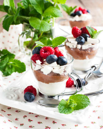 White chocolate and milk chocolate mousse with berries and meringueの写真素材