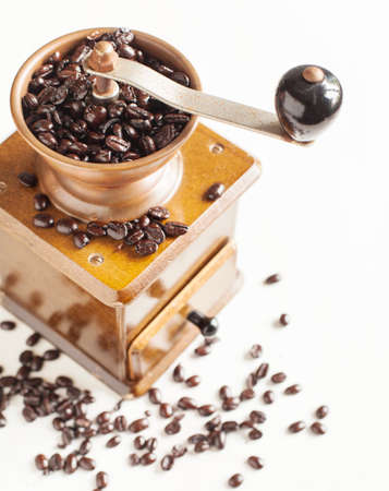 Antique coffee grinder with coffee beansの写真素材
