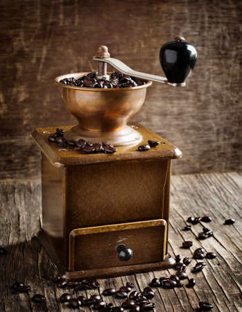 Antique coffee grinder with coffee beansの写真素材