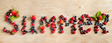 Assortment of summer fresh berries forming the word  Summer の写真素材