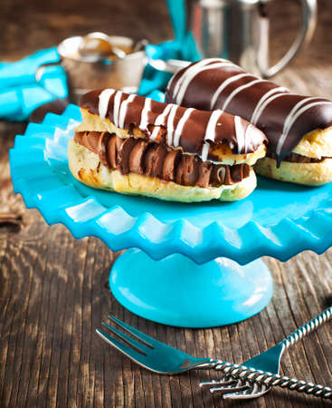 Chocolate eclairs and cup of espressoの写真素材