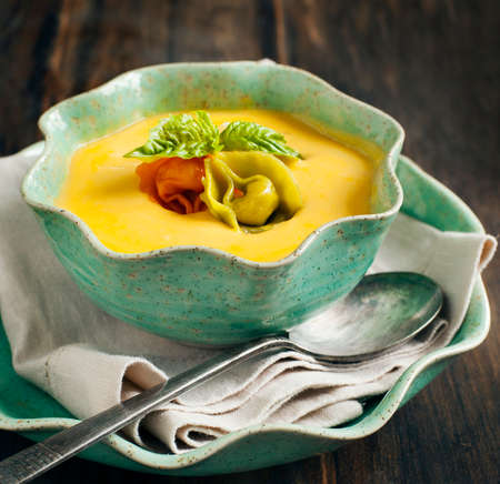 Pumpkin cream soup with cheese tortelliniの写真素材