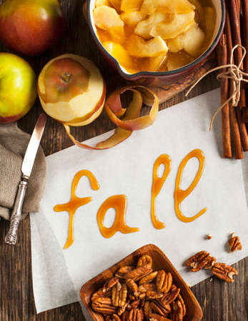 Autumn food background with apples, spices and nuts. Ingredients for baking apple pie and word Fallの写真素材