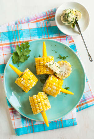 Cooked corn with herb butterの写真素材
