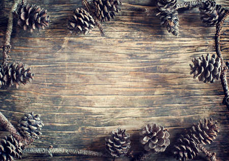 Pine cones on wooden backgroundの写真素材