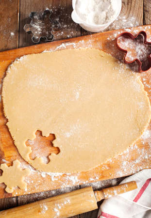 Making gingerbread cookies. Christmas baking background dough and cookie cutters.の写真素材