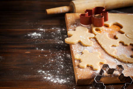 Making gingerbread cookies. Christmas baking background dough and cookie cutters.の写真素材