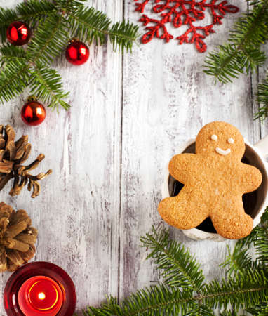 Christmas frame with Gingerbread cookie man, cup of tea and christmas decorationの写真素材